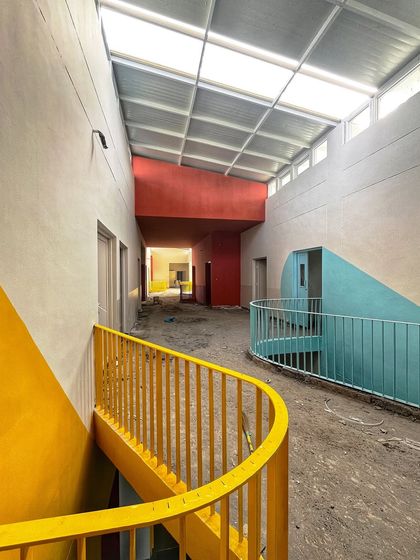 Even during construction, you can see how the design starts to take shape. The curves, colors, and natural light in this corridor at the SMBV school are all part of creating a more engaging educational environment.