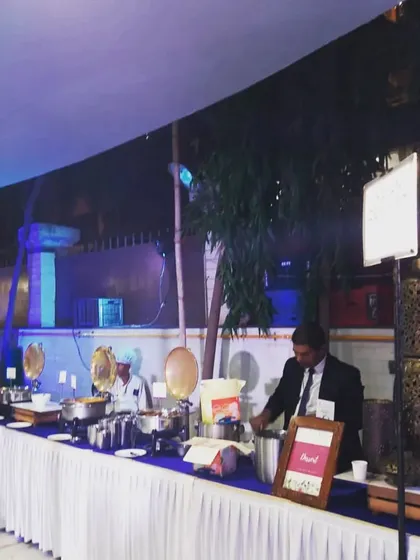 An evening buffet setup under a tent, with ambient lighting creating a warm and inviting atmosphere. This shows my capability in handling outdoor and nighttime events.