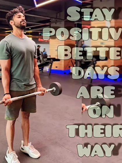 Holding a barbell during an arm workout. The message here is to stay positive, because better days and better results are on their way with consistent effort.