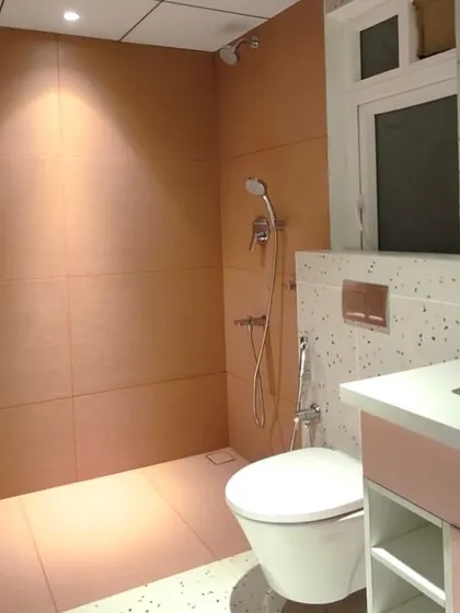 From a 3D render to reality. We brought this client's vision for a pink and terrazzo bathroom to life, focusing on every detail from the custom vanity to the warm, integrated lighting. This shows our commitment to executing a concept with precision.