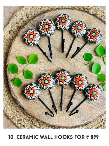 Our new mini ceramic wall hooks are here. This image shows a set of 10 in a beautiful red and orange floral design, perfect for hanging your macrame pieces, bags, or keys.