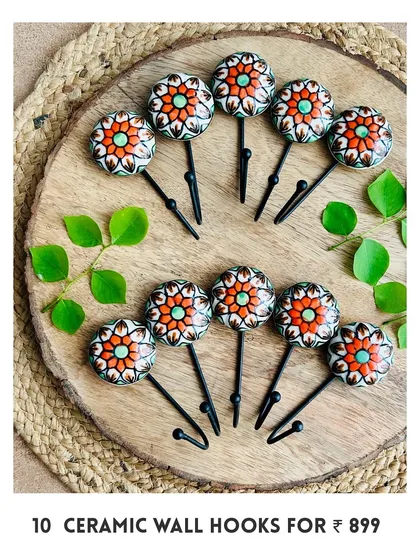 Our new mini ceramic wall hooks are here. This image shows a set of 10 in a beautiful red and orange floral design, perfect for hanging your macrame pieces, bags, or keys.