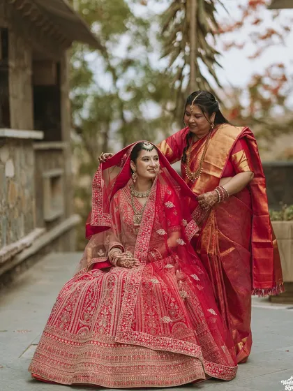 A touching moment between the bride and her mother, who helps adjust her veil before the ceremony.