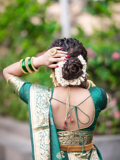 A beautiful shot of a bridal bun completely covered in fresh jasmine gajra, a timeless and fragrant choice for any traditional bride.