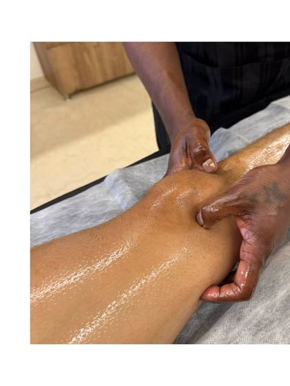 Your peace, your space, your home. Here, one of our therapists performs a therapeutic knee massage as part of an at-home session. We ensure you receive the same quality of care at home as you would in our clinic.