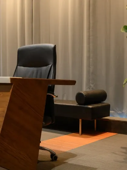 A detail shot of the custom conference table. The dynamic angled leg is finished in a warm veneer, contrasting with the sleek tabletop. It’s a small detail that adds a lot of character to the room.