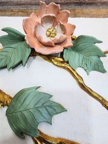 A close up of a sample flower with delicate, hand-sculpted petals and a textured center. These samples are a crucial part of my process, building a bridge between imagination and reality.