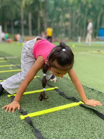 Agility is a key component of our training. Here, a young athlete tackles the agility ladder with focus and determination during a birthday party session, showing how we integrate real fitness drills into our fun events.