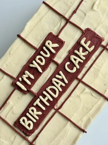 A close-up of the message on the gift-wrapped cake, showcasing the clean lettering and unique design.