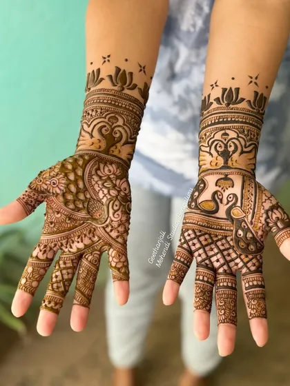 The back of the hands for the same engagement design, featuring swans and peacocks.