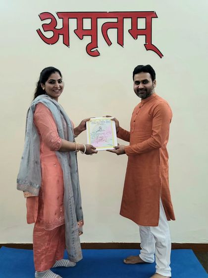 Awarding the title of 'Yogacharya' to a deserving student. This certification is a testament to her deep understanding and practice of yogic principles.