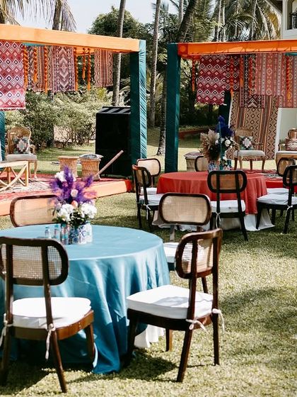 A wide view of the outdoor Haldi setup, with multiple seating areas and canopies decorated with Moroccan textiles, creating a relaxed and stylish atmosphere.