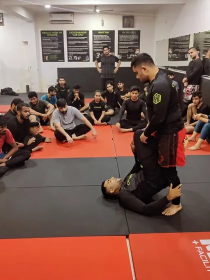Another angle of our coach teaching a guard pass. We emphasize hands-on instruction to ensure every student understands the mechanics of the technique.