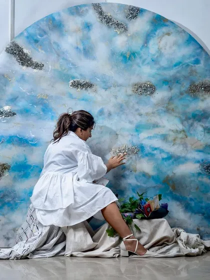 An arched resin art piece depicting a dreamy blue sky with fluffy white clouds and sparkling silver accents, creating a celestial and serene vibe.