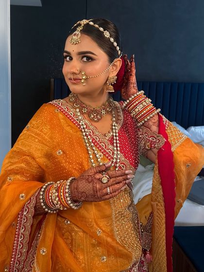 Adjusting her hair, this bride is all smiles. Her happiness is what makes the look truly complete.