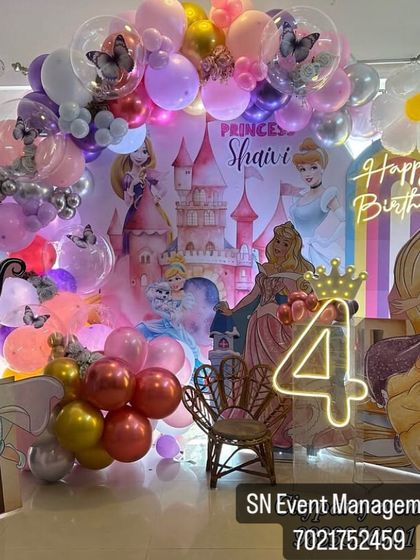 A magical Disney Princess castle theme for a 4th birthday. This elaborate setup includes a castle backdrop, multiple princess cutouts, and a light-up number '4'.