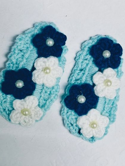 A pair of my floral hair clips in blue and white, adorned with a small pearl in the center of each flower.