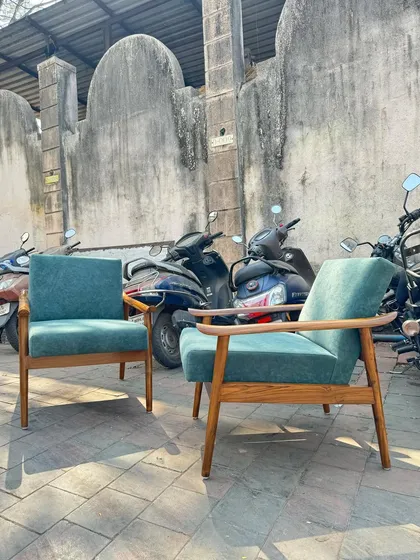 A front-on view of the two teal lounge chairs.