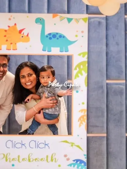 A happy family moment captured in the dinosaur-themed photo booth I created. These are the memories I love to help make.