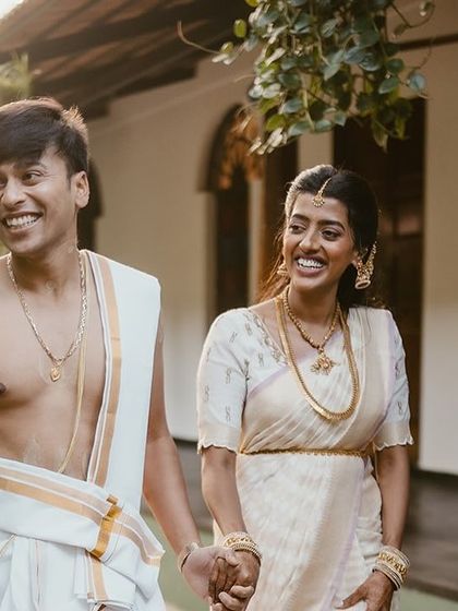 A candid shot of a couple walking and laughing together, capturing a natural and happy moment.