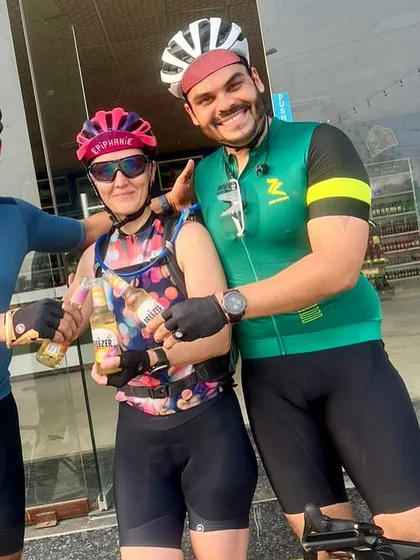 Celebrating the completion of a 100km ride with a well-deserved cold beer.