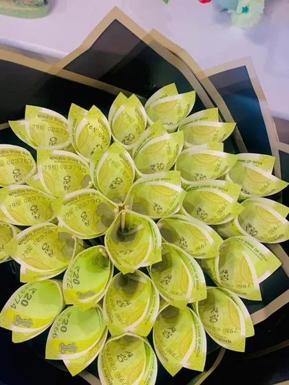 A close-up of the folded 20 rupee notes that make up the money bouquet. This shows the detail and care that goes into creating each "flower."