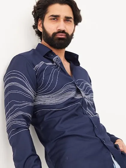 A relaxed pose shows how the wave embroidery moves with the fabric. This custom shirt is perfect for a sophisticated yet casual look.