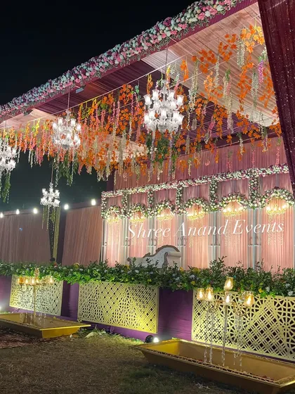 A close-up of the colorful floral stage, showing the detail in the hanging arrangements and the beautifully lit backdrop.