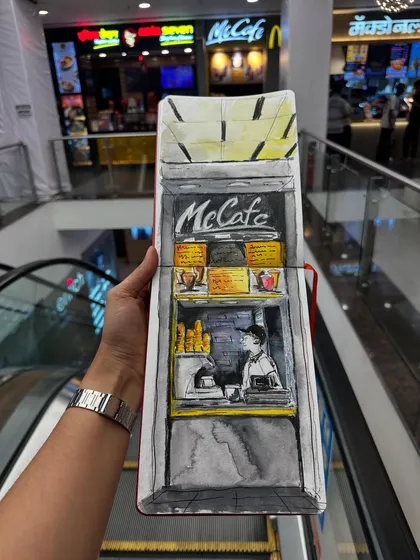 A sketch of the small McCafe kiosk at a local mall. Even in a modern setting, I love finding unique perspectives and capturing the everyday scenes of Mumbai life.