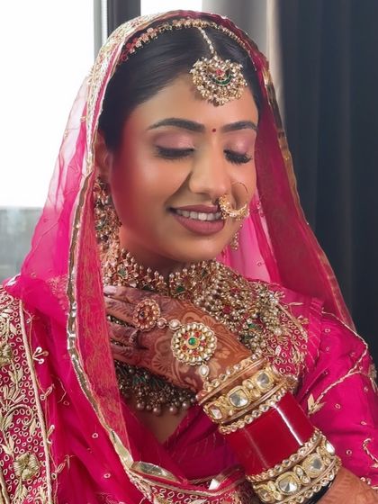 A close-up on the details of Vaishali's traditional Rajasthani look. The makeup highlights her features beautifully, from the intricate nath to the detailed borla, creating a look of pure elegance.