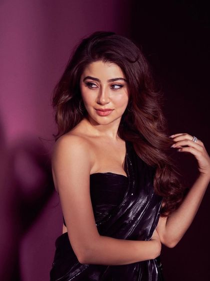 A beautiful portrait of Aditi Bhatia, showing off her soft waves and elegant makeup for the awards night.