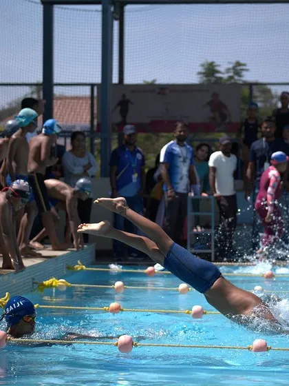 The explosive start of a race during one of our swim meets. We offer competitive swim training that covers everything from diving techniques to race strategy, preparing swimmers for success.
