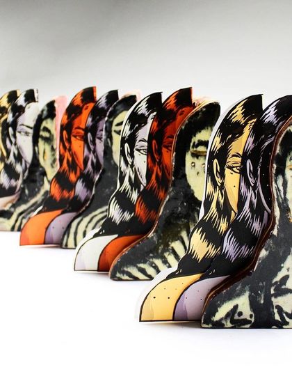 'Confrontation,' a mixed-media piece combining illustrated paper cutouts with ceramic slab-ware. The work explores layers of the self and the female gaze.