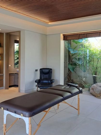 Another view of the home spa, highlighting the custom-built shelving with integrated lighting. This feature provides elegant storage for towels and spa essentials, adding to the room's functionality and serene aesthetic.