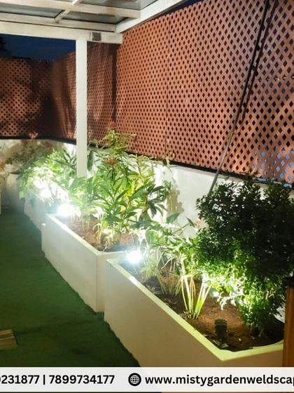 A close up of the lit planters against the PVC lattice privacy screen. We carefully select plants that thrive on terraces and arrange them for the best visual impact.