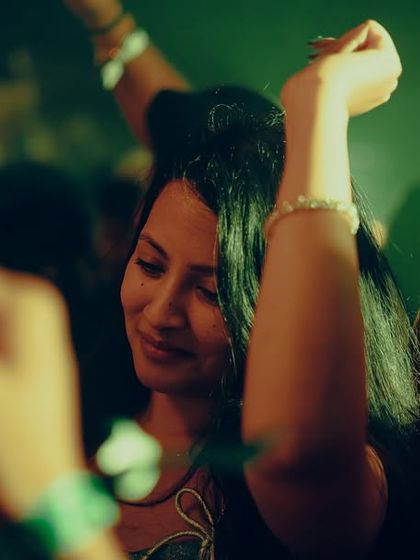 A candid of someone enjoying the music on the NYE dancefloor.