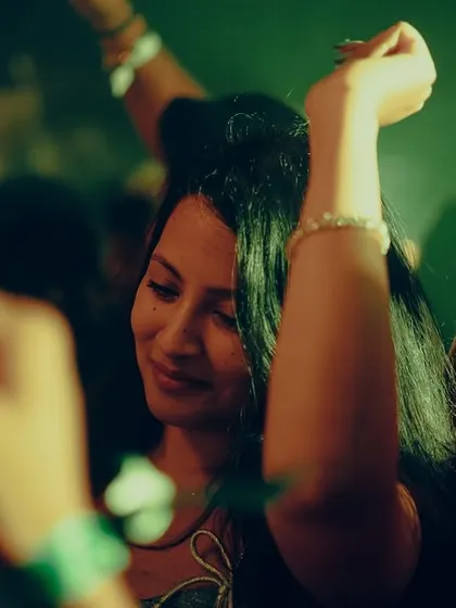 A candid of someone enjoying the music on the NYE dancefloor.