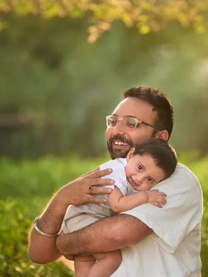 A quiet, tender moment as a son rests his head on his father's shoulder. It's not just about the big laughs; I also capture the gentle, loving connections.