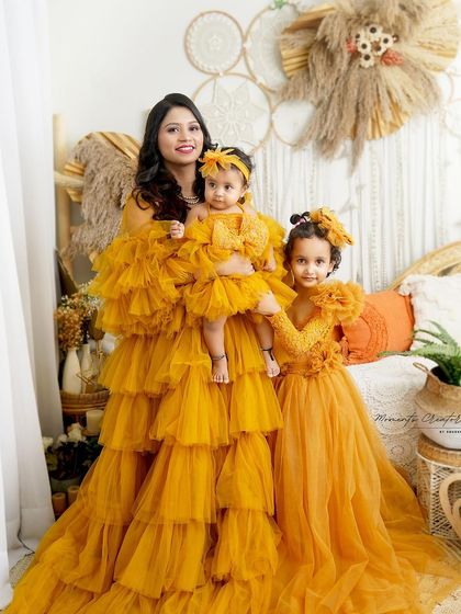 A mother and her two daughters, all in matching yellow. This portrait beautifully captures the bond between a mother and her girls.