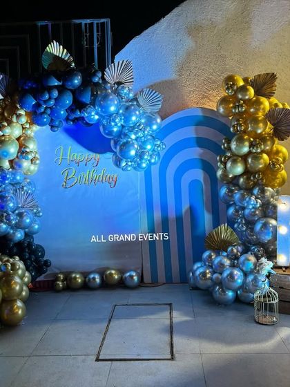 Another grand birthday setup, this time with a cool blue and gold theme. I used a rainbow-striped backdrop, multi-toned balloon arches, and large marquee letters for a modern and stylish look.