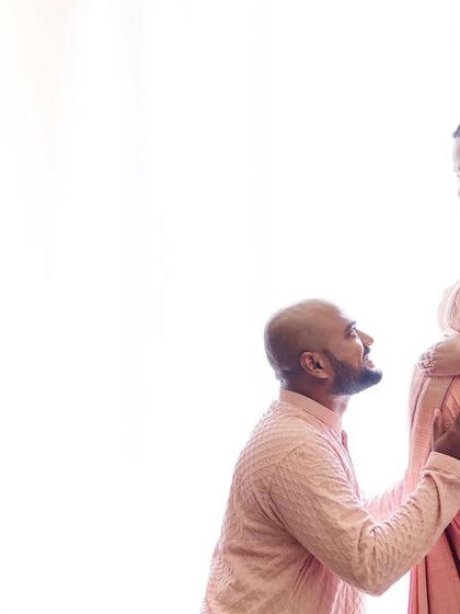 A bright and airy high-key portrait. Using a white background and bright light, this image creates an angelic and pure feeling as the partner kneels in admiration.