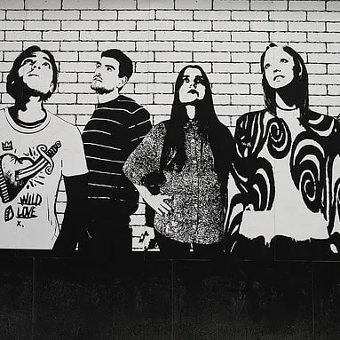 A high-contrast, black and white mural depicting figures against a brick pattern. This graphic style is effective for creating a bold, urban look in commercial interiors.