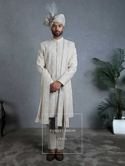 A full view of the 3D floral ivory sherwani, complete with a matching stole. The entire look is designed to reflect the emotions woven into every detail of a wedding.