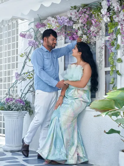 A lovely couple's portrait against our floral window backdrop. The unique fabric of the 'Snowflake' gown catches the light, creating a beautiful, subtle rainbow effect.