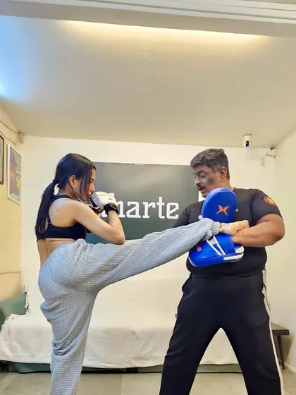 I teach you to be powerful, no matter your size. Here we are practicing a high kick, building strength and confidence with every session. This is about finding the fighter in you.