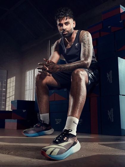 Styling Suryakumar Yadav for a Reebok campaign. The look is focused on performance, with athletic wear that highlights the new shoe model against a backdrop of shoeboxes, creating a strong visual story.