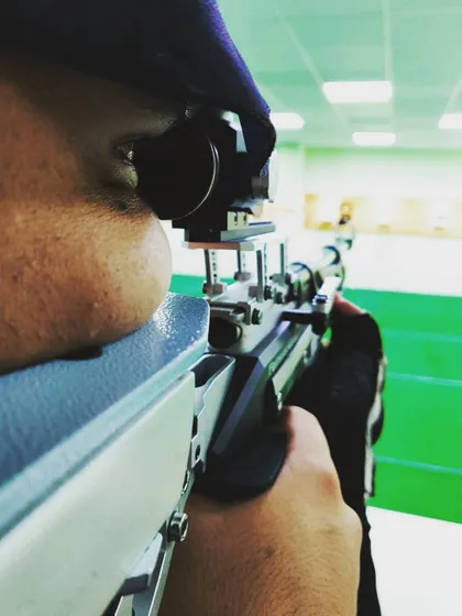 This is what pure focus looks like. A close-up of a shooter's eye, perfectly aligned with the sights of their air rifle, just moments before taking the shot.