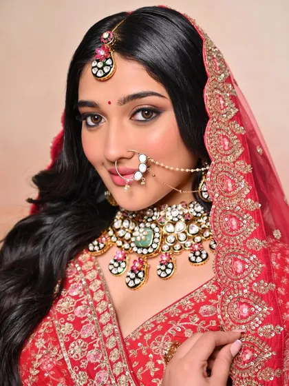 A close-up of the beautiful nath and eye makeup. We teach our students how to work with traditional jewelry for a complete bridal look.