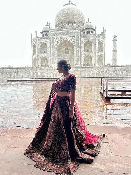 A breathtaking shot of a bride in our maroon velvet lehenga at the Taj Mahal. This shows how our outfits can be used for stunning pre-wedding or post-wedding photoshoots.