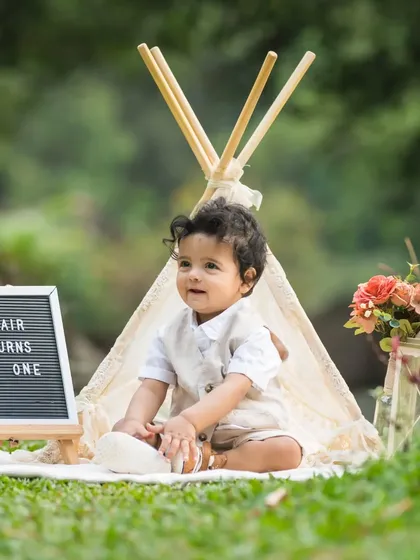 The other half of the twin pair, this handsome little boy celebrates his first birthday in a matching outdoor setup.